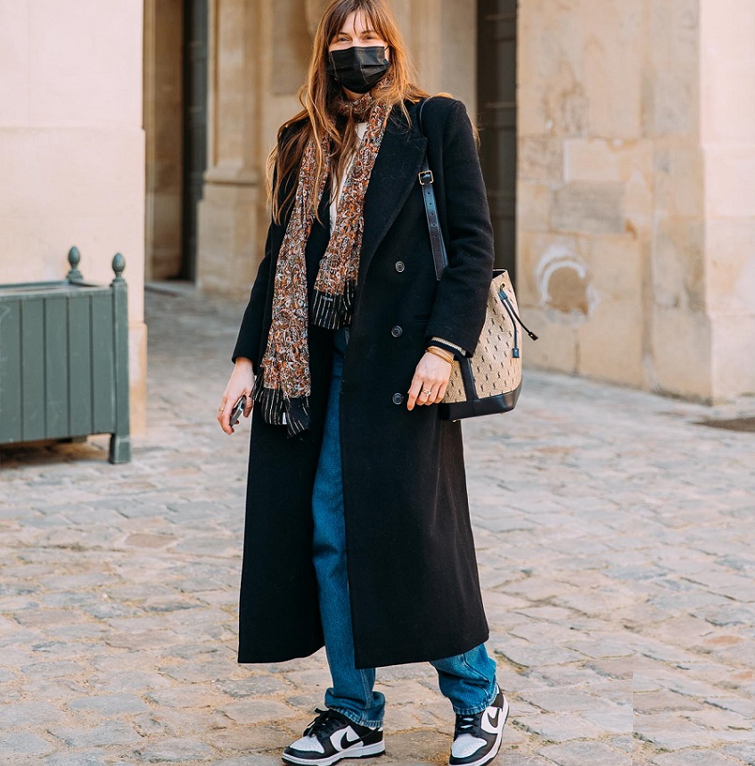 picture of a woman walking in stylish outfit and sneakers