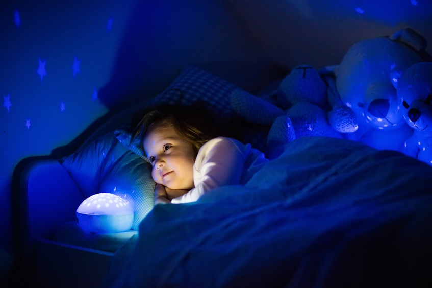 little girl sleeping with night light