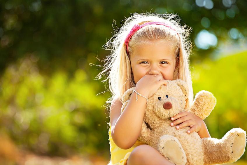 Little girl carrying plush toy