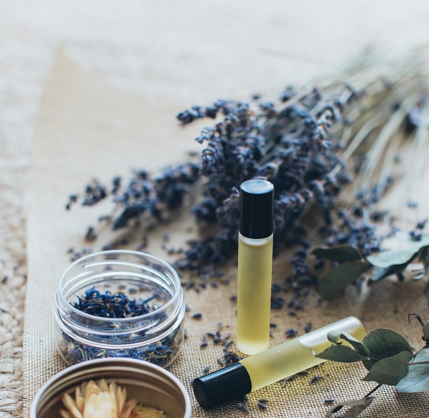 picture of lavender oil beside a fresh lavender