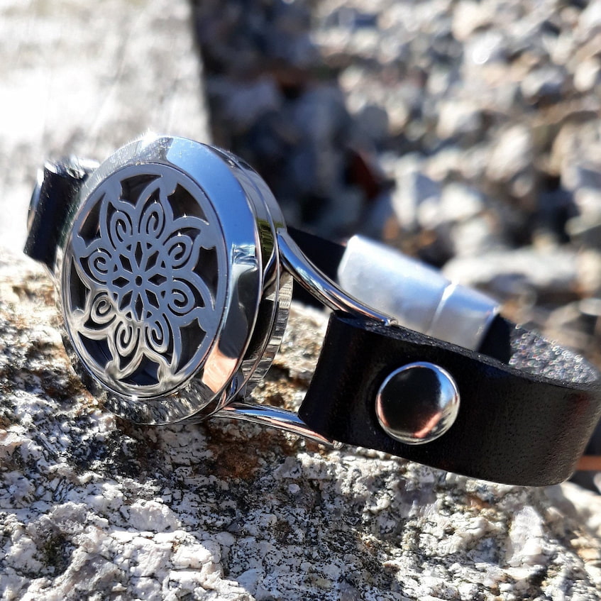 essential oil watch laying on the rock