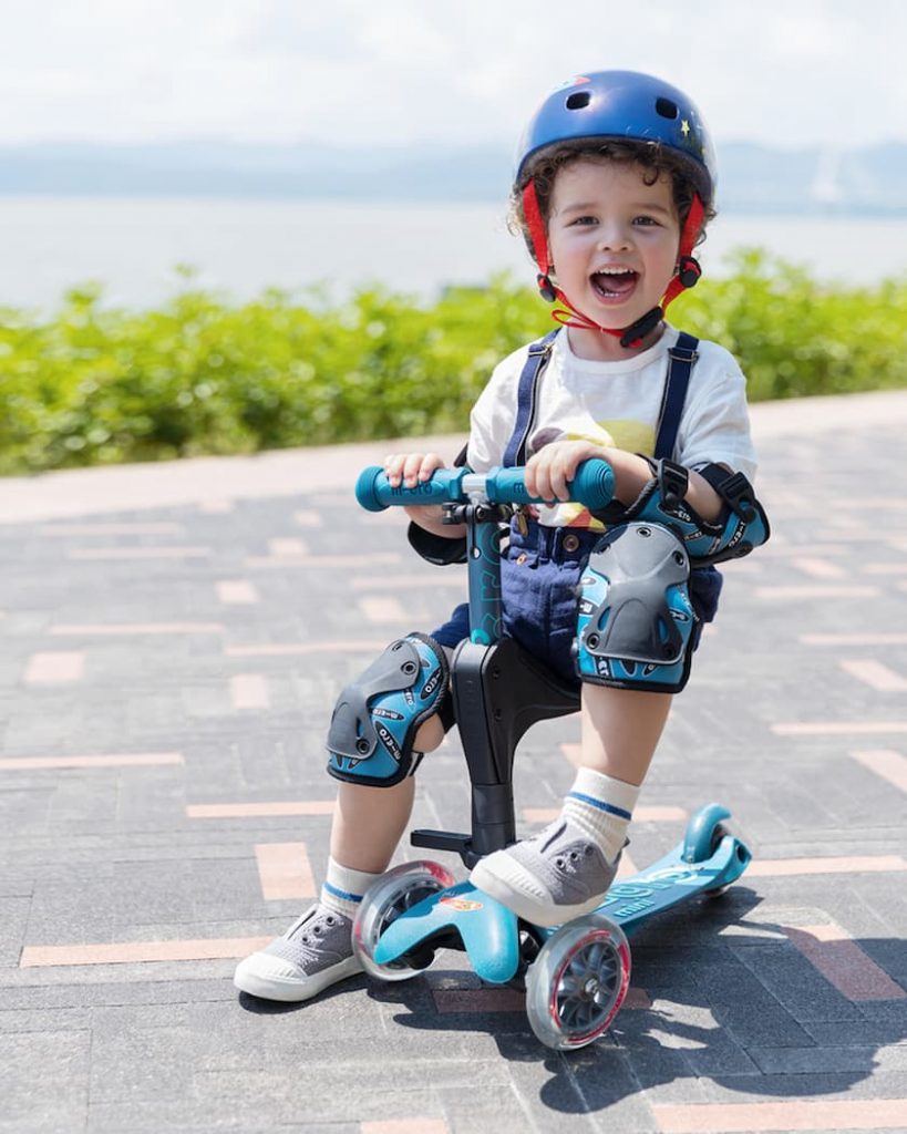 kid with knee pads and helmet