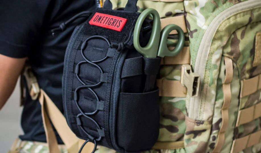 Man caring tactical bag with tactical med kit on the side