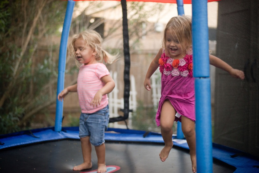 Little girls jumping on trampoline